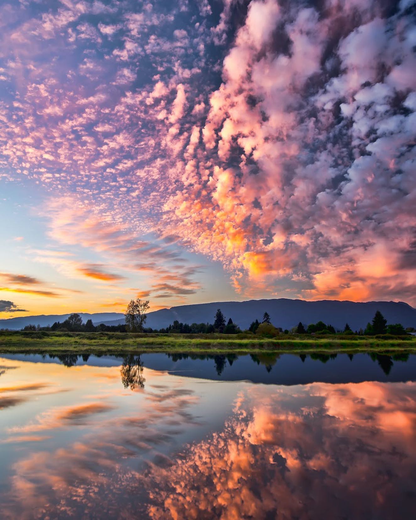 Pitt Meadows, BC, CanadaSymmetrical Photography of Clouds Covered Blue Sky by James Wheeler