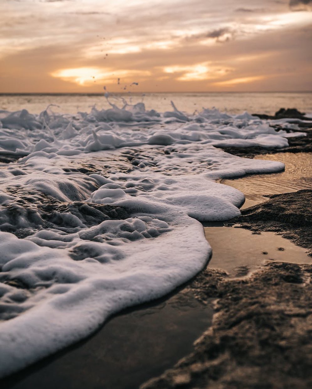 Sea Waves Crashing on Shore during Sunset by KEHN HERMANO